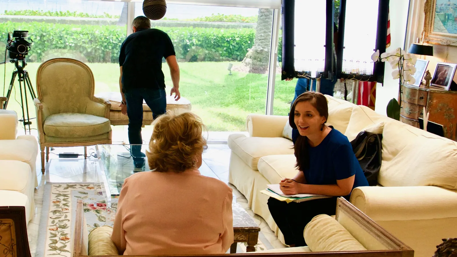 Director interviews woman in behind the scenes photo.